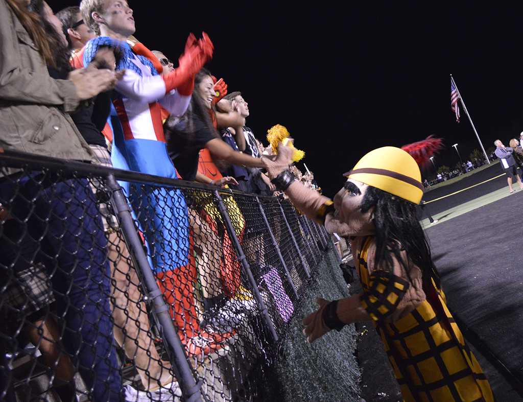 The Highlander greets cheering super-fans at the Homecoming Game. 