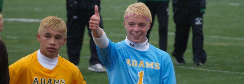 Goalkeeper Eric McClean gives a thumbs up to the crowd at a soccer game. 