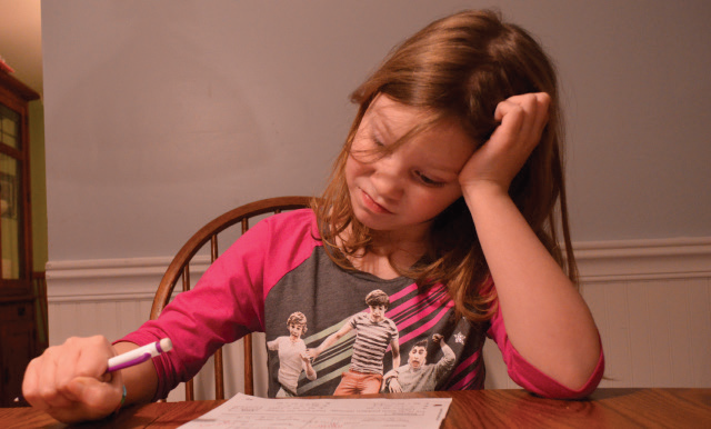 A frustrated second grader struggles with complicated new math problems.