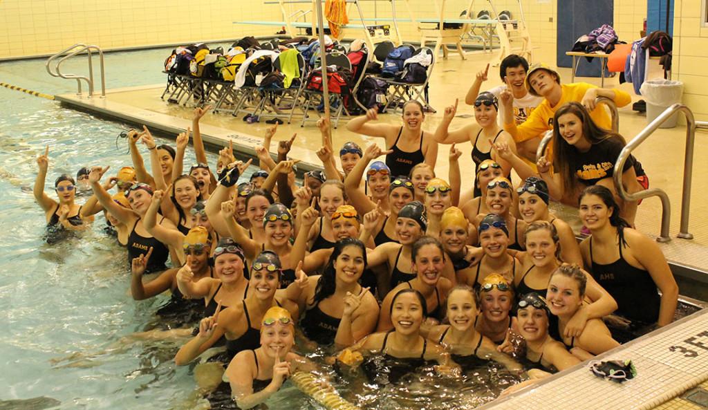 The girls swim and dive team celebrates after defeating rival Seaholm.