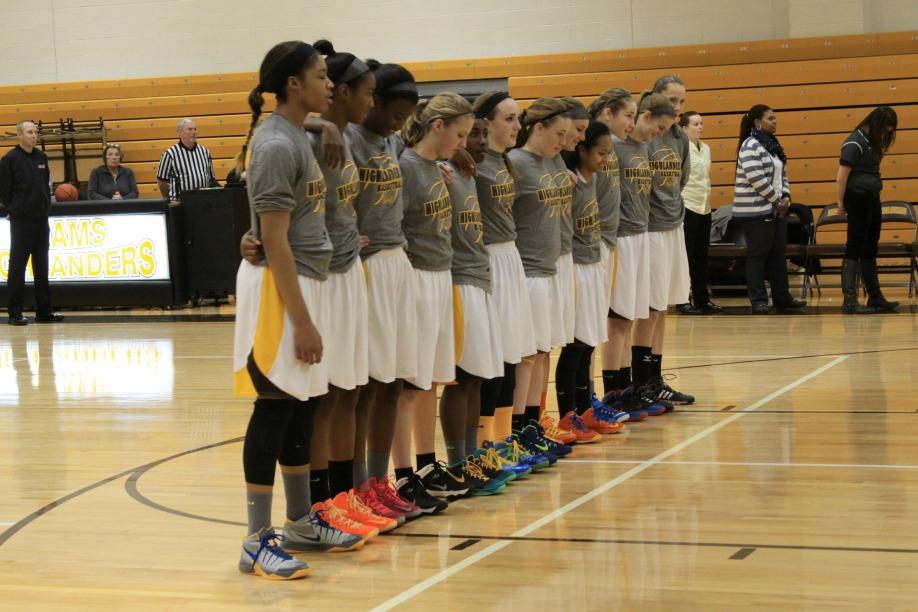 The+AHS+Girls+Basketball+team+lines+up+during+the+national+anthem.