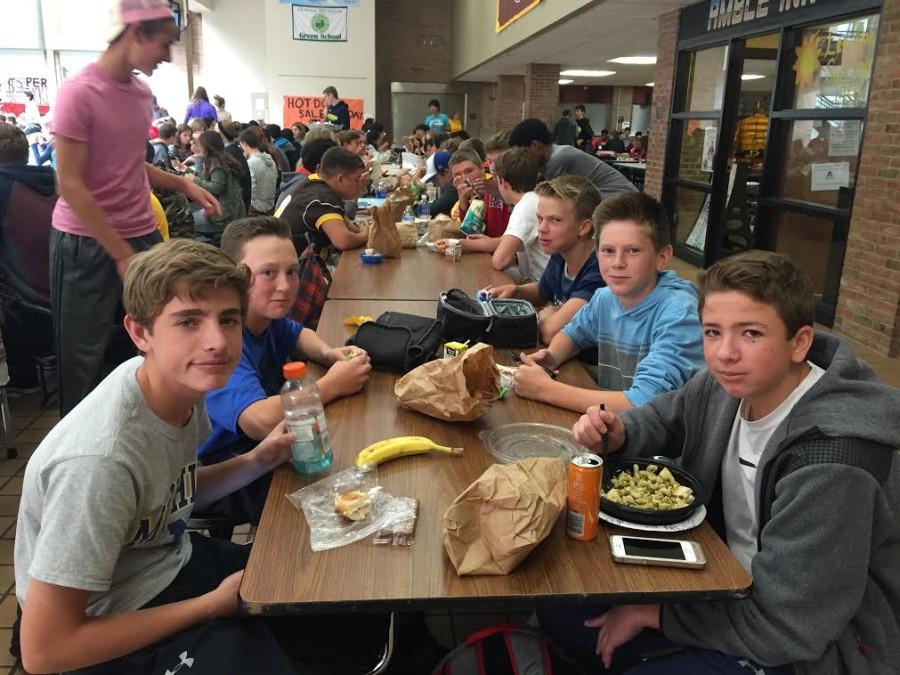 Freshman boys gather around the lunch table to eat and chat