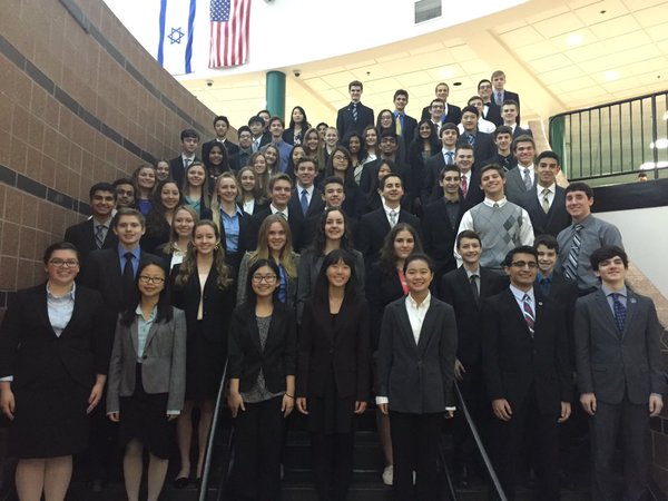 Adams DECA students pose on the staircase of Lake Orion High School