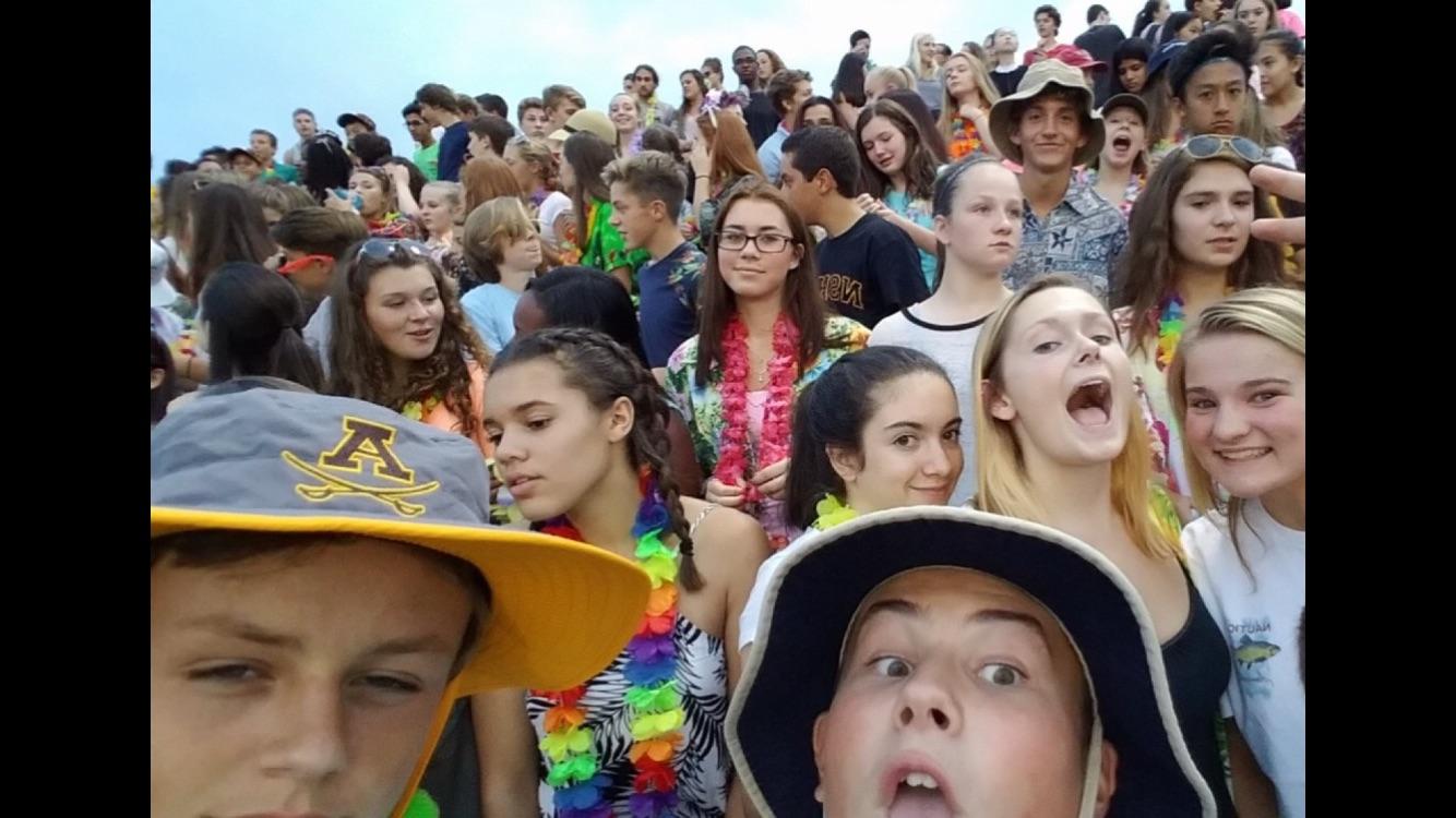 A group of juniors enjoy a Friday night in the student section before the new restrictions.