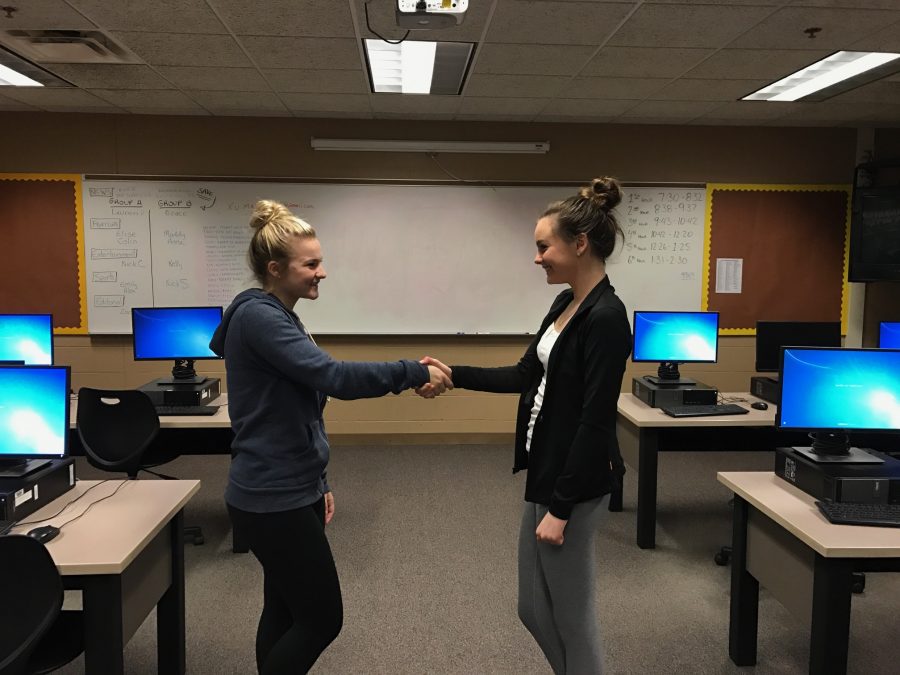 This display illustrates a peaceful exchange of power between two people with a different set of characteristics and beliefs. (Left to right: Maddy Fleury, Elise Delikat)