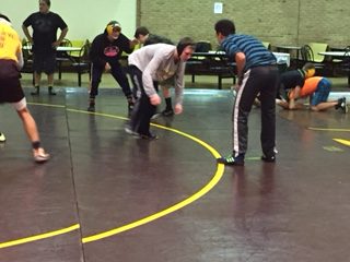 Freshmen Kenny Jackson wrestles teammate Roman Lopez at practice.