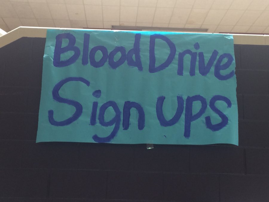 Student Council creates a banner to encourage participation in the blood drive.
