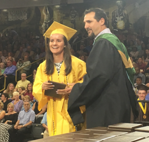 English teacher Mr. Dave Lovalvo gives his daughter, Sydney Lovalvo, her diploma. Lovalvo’s two children - Sydney and Jack - graduated this year. Both seniors received their diplomas from their dad.