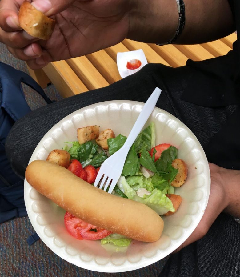 Crusty bread stick with limp salad.