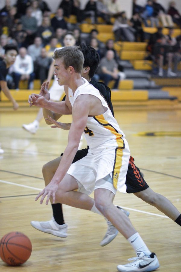 Jake Schuler drives to the basket during a game against Utica High School.
