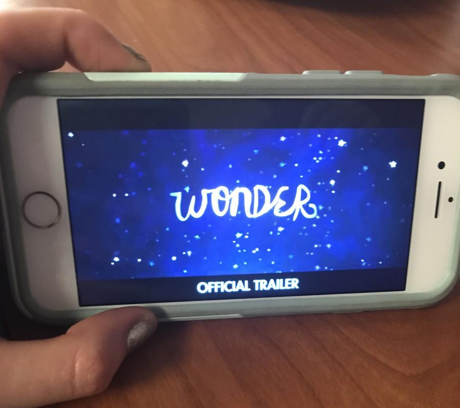 Student watches Wonder trailer on her phone.