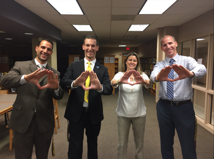 (pictured left to right): Rochester Adams Principal Mr. Pasquale Cusumano, Rochester Adams DECA Advisors Mr. Vince LoPiccolo and Mrs. Christy Clement, and Rochester Adams Vice Principal Mr. Todd Calcamuggio make the signature “DECA Diamond”.