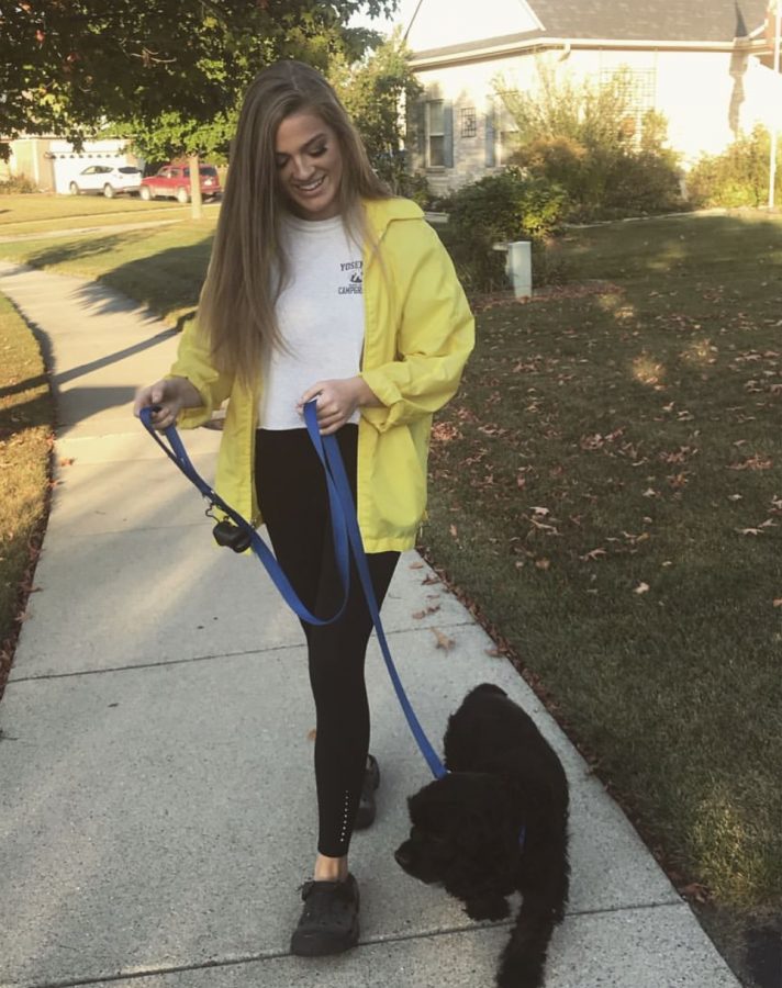 Olivia Davies shows off her style while walking her dog.