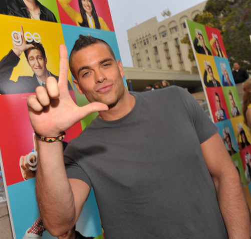 Salling, while still acting on Glee, during a concert doing the show’s trademark hand gesture.