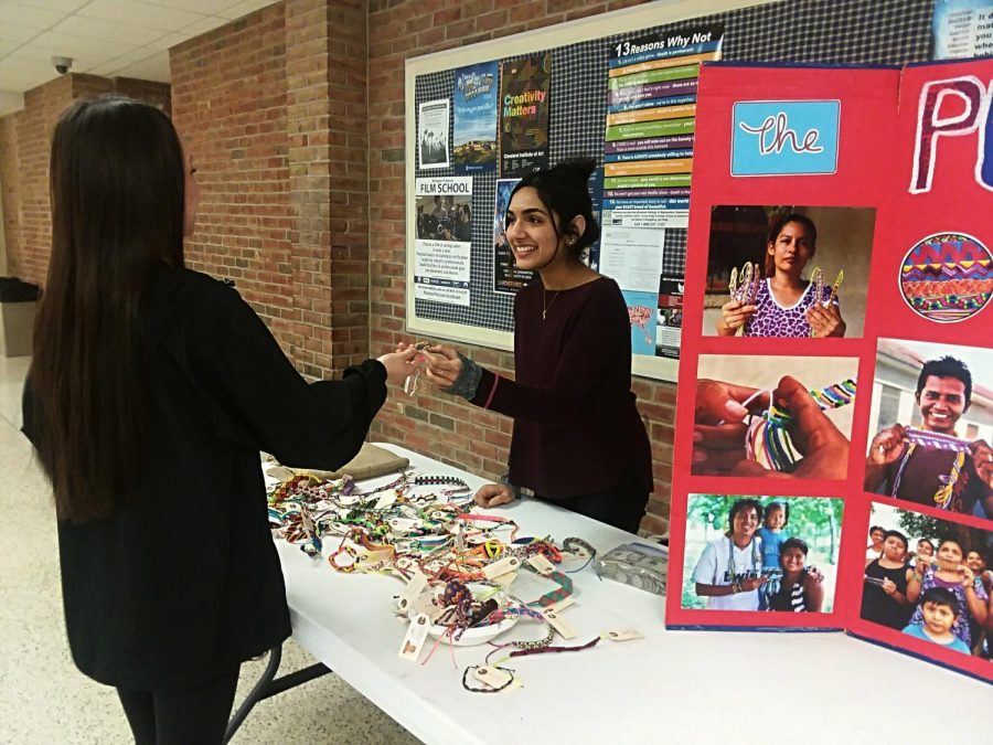 Student Roma Kamat selling pulseras during lunch.