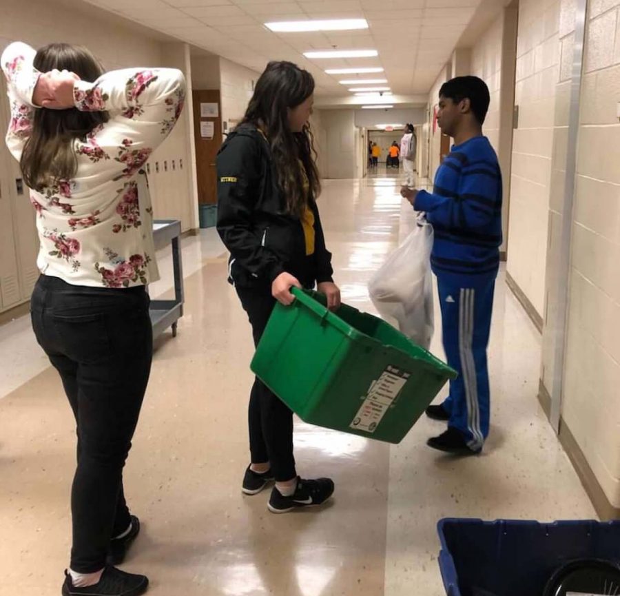 Peer mentors help students do the recycling for each classroom in the building.