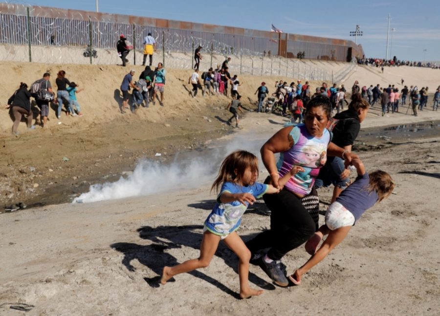 Maria Lila Meza Castro and her two twin daughters running from the tear gas.