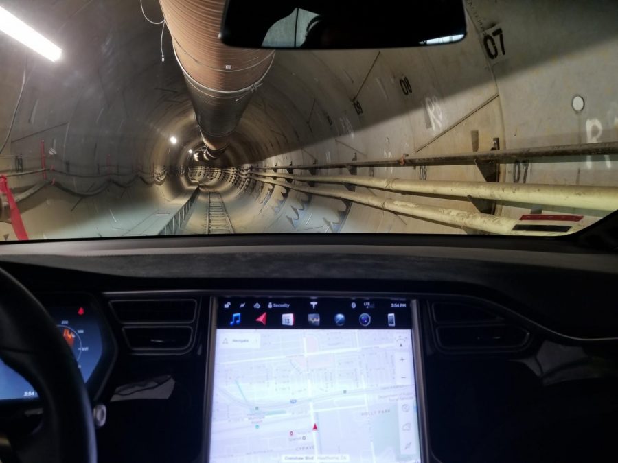 View from inside the cockpit of a tesla model x, traveling through the hyperloop.