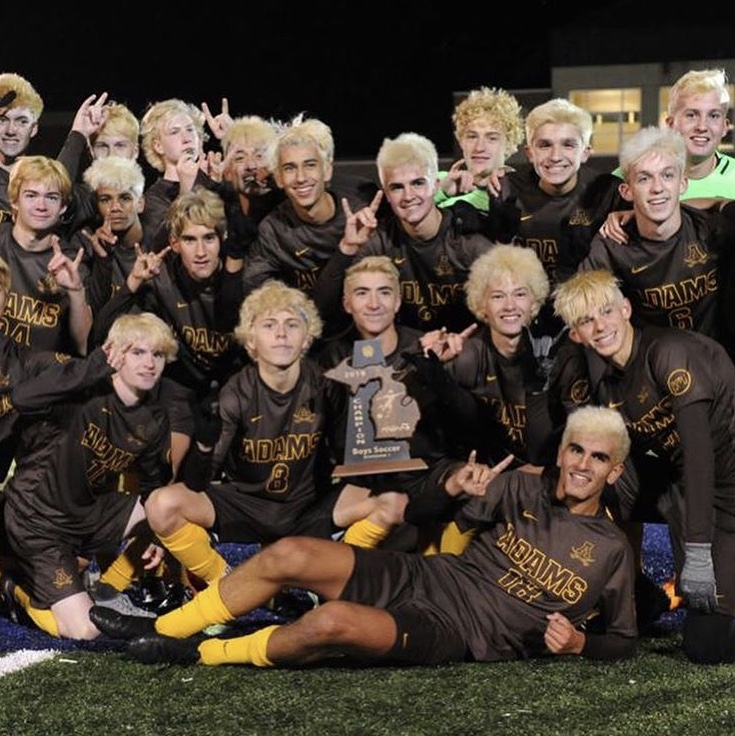 Rochester+Adams+Mens+Soccer+posing+with+the+district+title%0A