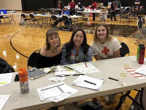 Members of Student Council signing 	    students up for the blood drive
