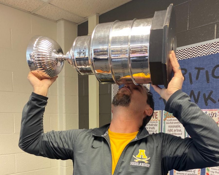Lovalvo celebrating his can drive victory by hoisting and kissing the Canley Cup. 