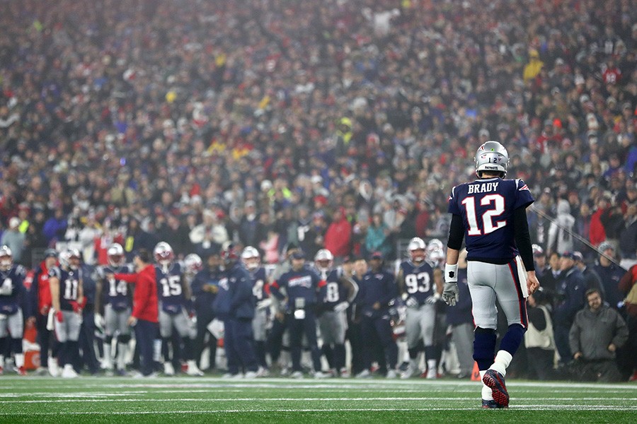 Brady walking to the sideline after throwing an 	       
interception.
