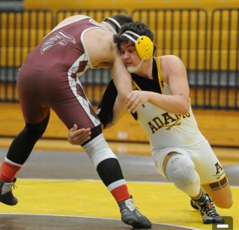 Senior Wrestler Chase Montour attempting a shot at his opponent.