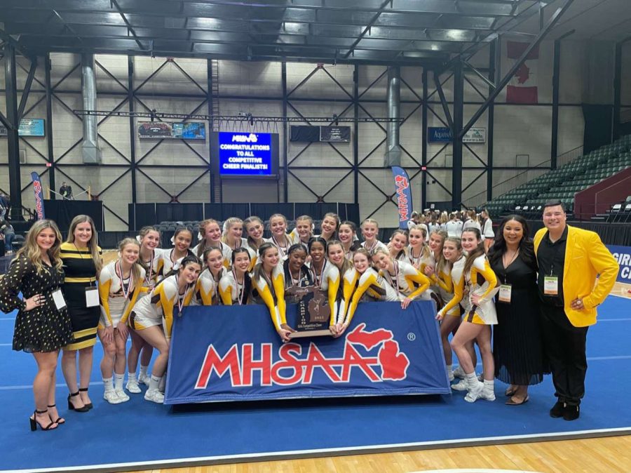 Adams cheer team with state championship trophy.