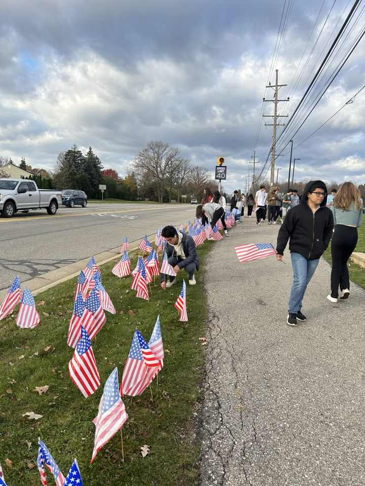 Adams students place flags in front of the school for Veterans Day. (Photo Credit: Dave Lovalvo)
